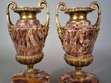 pair of antique vases on marble bases on a gray background