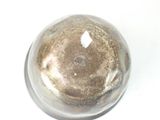 a silver object on a white surface with a white background