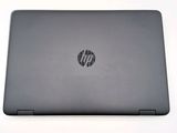 the back view of a laptop computer with a black hp logo on the screen