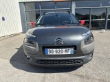 the front of a grey citrole parked in front of a building