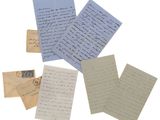 a pile of old letters and envelopes sitting on top of each other