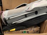 a pile of luggage sitting in a cardboard box