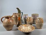 a lot of vases that are sitting on a table