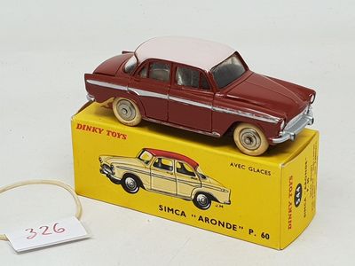 a red toy car sitting on top of a yellow box