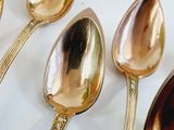 five spoons that are sitting on a table