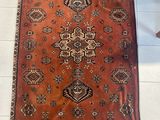 rug on the floor in a room with a chair and a table