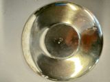 a silver bowl with a hole in the middle of it