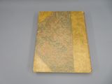 a book with a gold cover sitting on a table