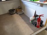 a fire extinguisher in the corner of a kitchen