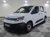 la camionnette blanche est garée sur un sol carrelé en damier