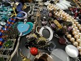 a table with many different types of jewelry on it