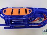 a blue and orange sled that is on a table
