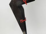 sculpture of a knife on a black base with a red handle