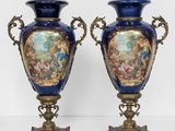 pair of blue and gold vases sitting on top of a table