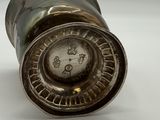 a close up of a metal object on a white surface
