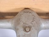 a close up of a metal object on a wooden table