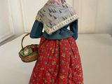 figurine of a woman with a basket of vegetables