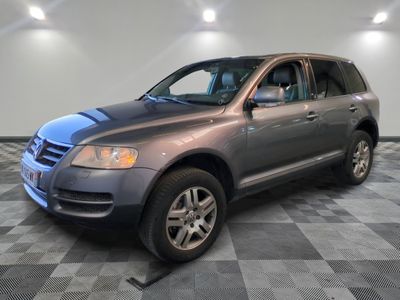 a picture of a gray volkswagen suv parked in a garage