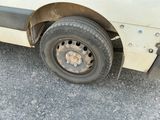 a white van that has a flat tire on it