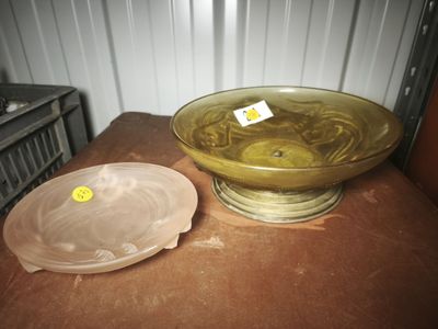 a yellow bowl sitting on a table next to a plastic bowl