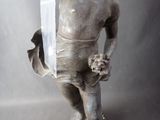 a statue of a man holding a knife in his hand