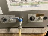 an image of a water heater with a hose attached to it