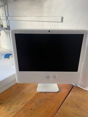 an apple desktop computer sitting on top of a wooden desk
