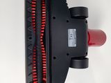 a close up of a red and black vacuum cleaner