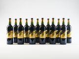 six bottles of wine are lined up in a row on a white surface