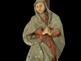 wooden statue of a woman holding a cross with a man on it