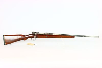 a rifle with a wooden barrel on a white background