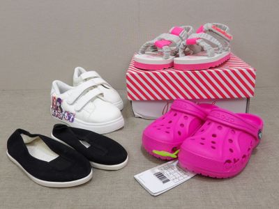 three pairs of crocs shoes and a shoe box on a table