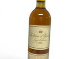 a close up of a bottle of wine on a white surface
