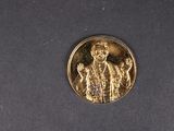 une image représentant une médaille d'or sur laquelle figurent un homme et une femme