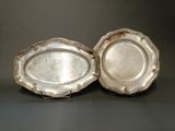 pair of silver plated trays on stand on black background