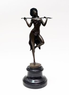 bronze statue of a woman playing a flute on a marble base