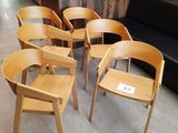 six chaises et un canapé dans une pièce aux murs en bois
