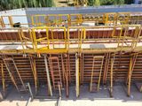 yellow scaffoldings on the side of a building under construction