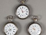 three silver pocket watches with roman numerals and roman numerals on them