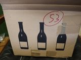a cardboard box with three bottles of wine in it