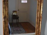 a mirror sitting on a mantle in the corner of a room