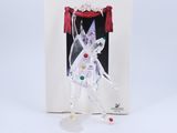 an ornament in a box with a picture of a woman in a white dress