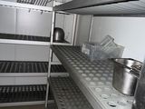 shelves with pots and pans on them in a kitchen