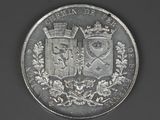 an image of a silver coin with two coats of arms on it