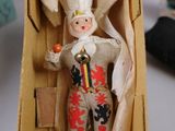 a small doll in a cardboard box on a table