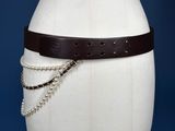 a white mannequin torso with a brown belt on it