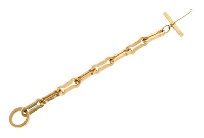 un gros plan sur un bracelet en chaîne dorée orné d'une croix