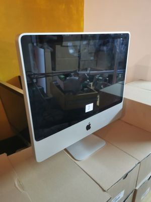 a computer monitor sitting on top of a cardboard box