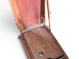 a wooden box with a lid open on a white surface