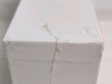 a close up of a piece of white paint on a piece of wood